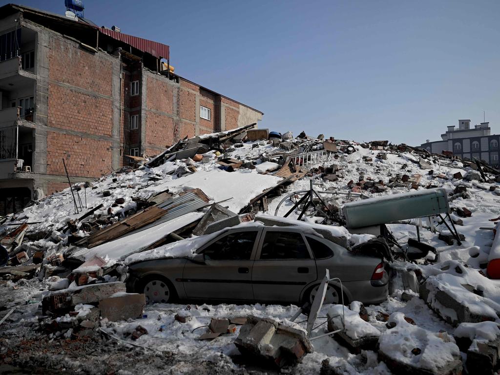 A car lies under rubble of collapsed buildings in the Elbistan district of Kahramanmaras. Picture: AFP