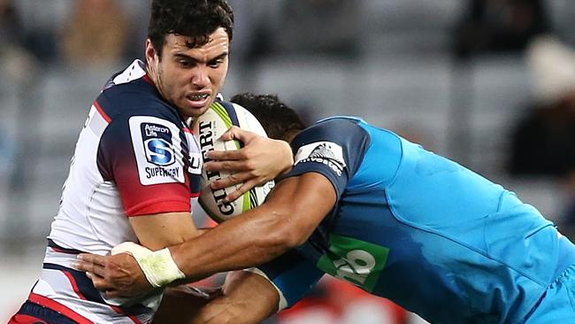 The Rebels’ Jack Debreczeni is tackled by George Moala of the Blues.