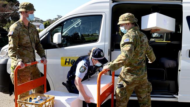 Members of the Australian Defence Force and NSW Police gather at Prairiewood Leisure Centre for a briefing before hitting the streets of south west Sydney. Picture: Toby Zerna