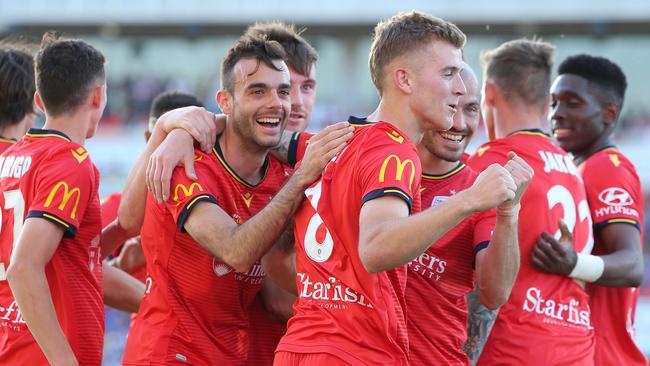 Adelaide United players celebrate a Riley McGree goal against the Jets. Picture: Getty Images