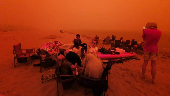 Twitter picture taken by Alastair Prior as people gather together at an evacuation centre on the beach at Batemans Bay. Picture: Twitter/@alastairprior