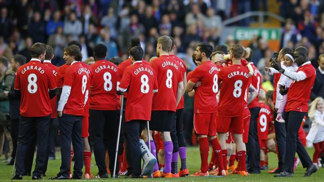 Liverpool players wear T-shirts bearing the name and number of Steven Gerrard after the match.