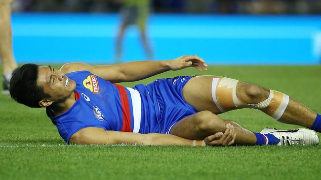 Lin Jong lays on the ground in pain. Picture: George Salpigtidis