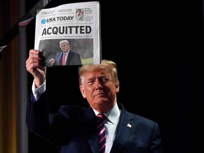 Donald Trump celebrating with a newspaper from the first time he was impeached. He’s since been impeached again, and now hopes to be acquitted by Facebook’s Oversight Board. Picture: Nicholas Kamm/AFP