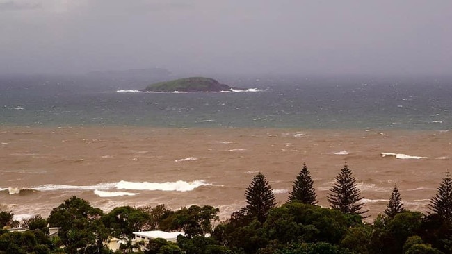 Flood waters reach the ocean off Hills Beach at Korora last month. Photo by Evol Coutman.