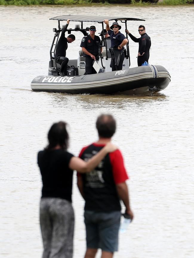 The family look on as police retrieve the man’s body. Pic: Calum Robertson