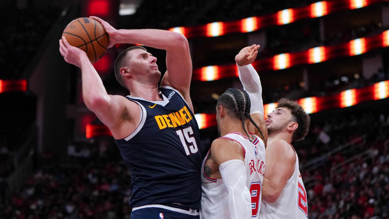 HOUSTON, TEXAS – NOVEMBER 24: Nikola Jokic #15 of the Denver Nuggets grabs a rebound as Dillon Brooks #9 of the Houston Rockets defends in the fourth quarter of an NBA In-Season Tournament game at Toyota Center on November 24, 2023 in Houston, Texas. NOTE TO USER: User expressly acknowledges and agrees that, by downloading and or using this photograph, User is consenting to the terms and conditions of the Getty Images License Agreement. Alex Bierens de Haan/Getty Images/AFP (Photo by Alex Bierens de Haan / GETTY IMAGES NORTH AMERICA / Getty Images via AFP)