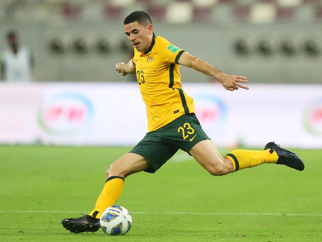 Tom Rogic strikes the ball during the 2022 FIFA World Cup Qualifier match between Australia and China PR at Khalifa International Stadium. Photo by Mohamed Farag/Getty Images.