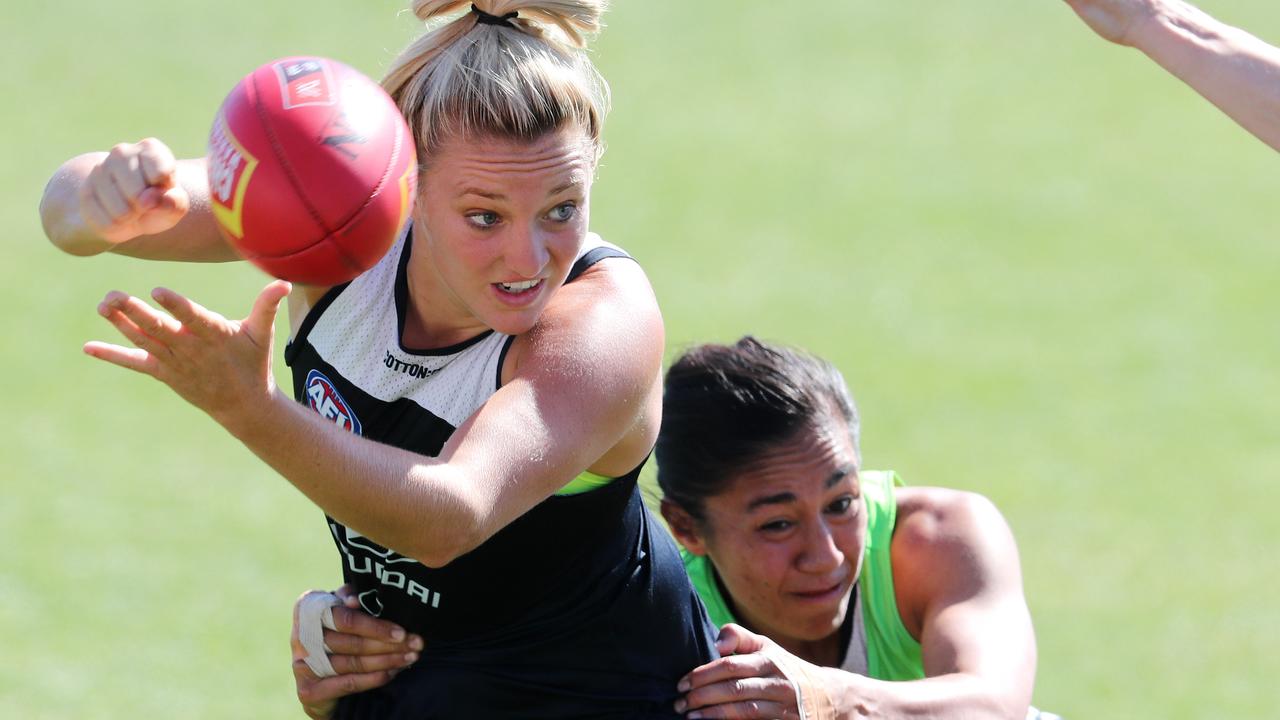 Jess Hosking is tackled by Darcy Vescio. Picture: Michael Klein