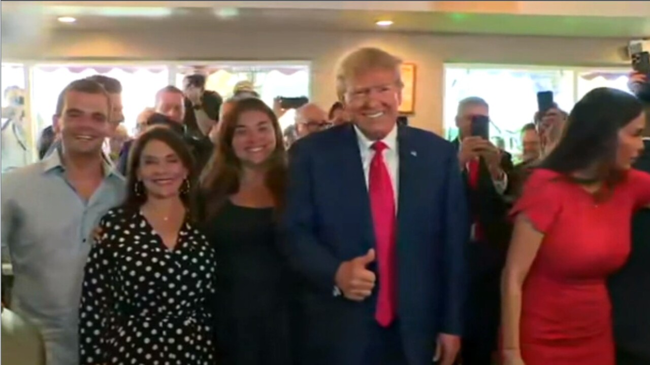 Donald Trump visits Miami bakery and is prayed over after court case