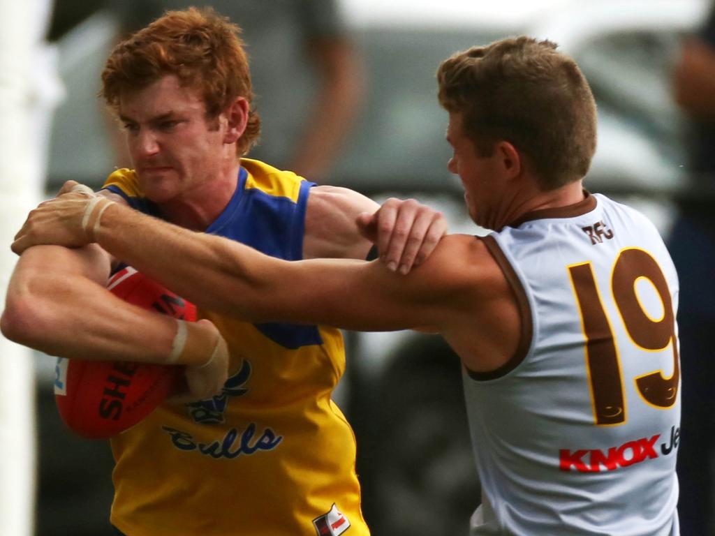 Morrison tries to break the tackle of Rowville's Jake Dermott. Picture: Brendan Francis