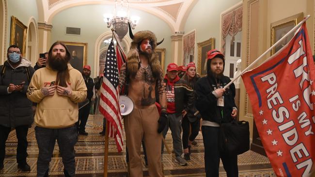 Supporters of US President Donald Trump, including member of the QAnon conspiracy group Jake Angeli, aka Yellowstone Wolf (C), enter the US Capitol on January 6. Picture: Saul Loeb/AFP