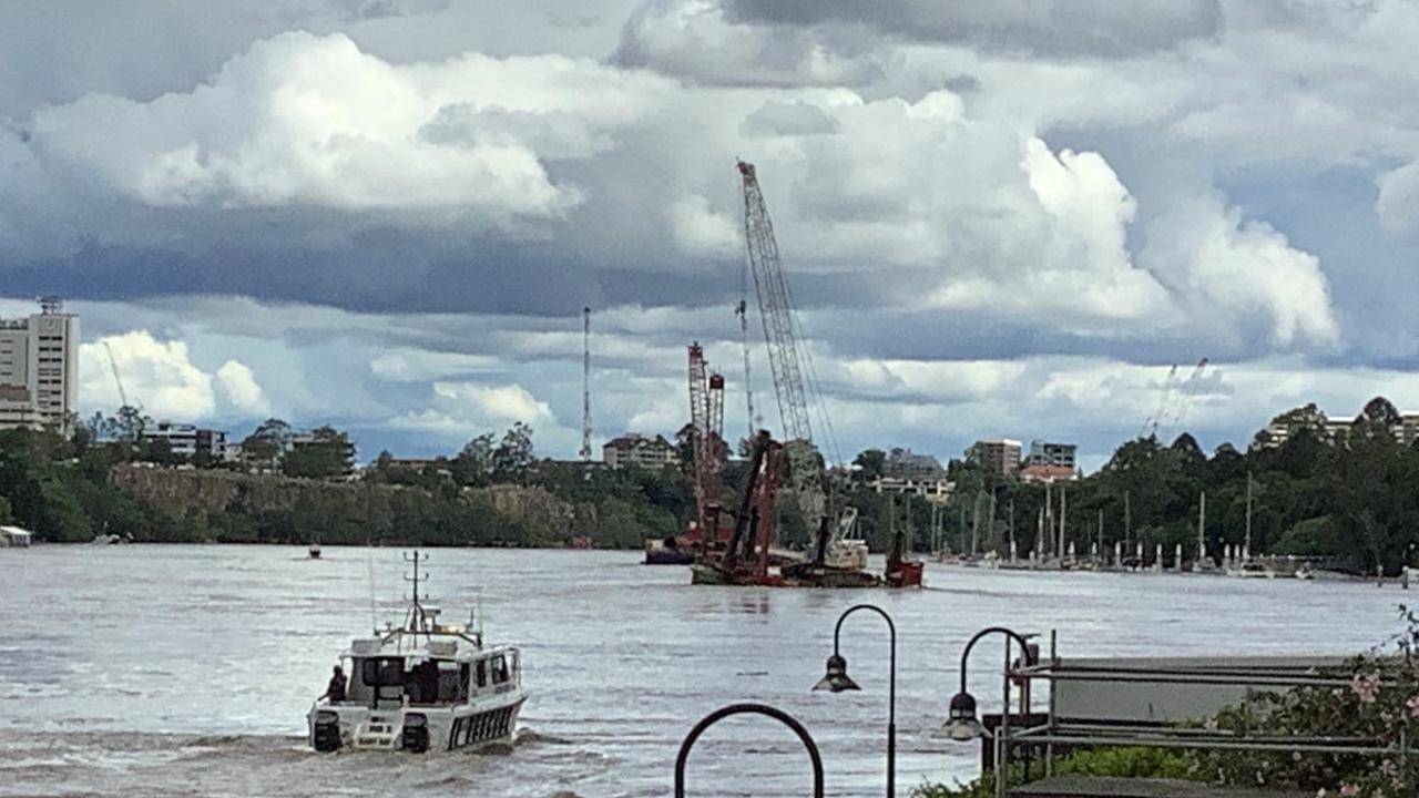 A pontoon carrying a crane has broken loose from its mooring. Picture: Queensland Police