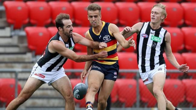 Jordan Gallucci cops heavy attention from Collingwood’s Steele Sidebottom (left) and Jaidyn Stephenson during the AFLX tournament last week. Picture: Calum Robertson