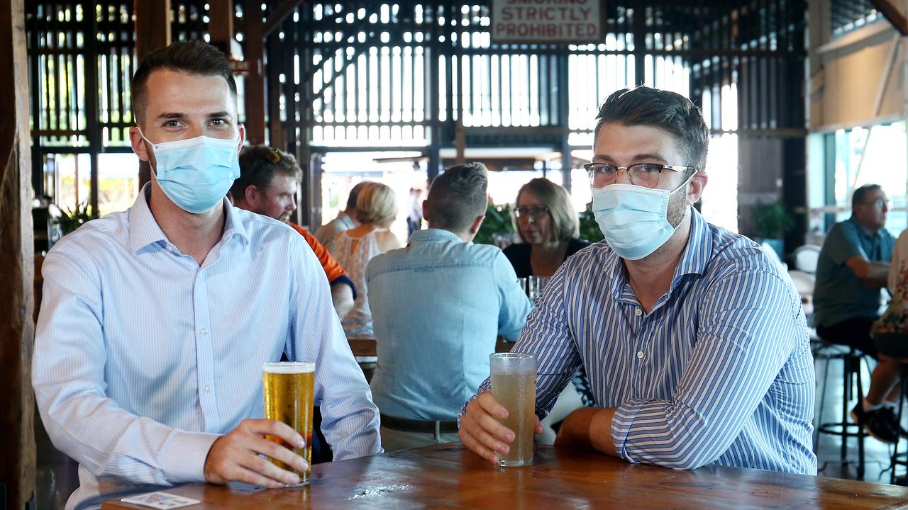 Cairns residents enjoying a beer while wearing masks and socially distancing from others. Picture: Brendan Radke