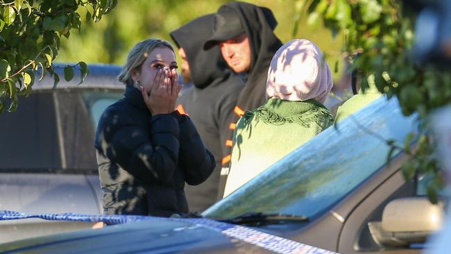 Loved ones gathered after the violent shooting. Picture: Brendan Beckett