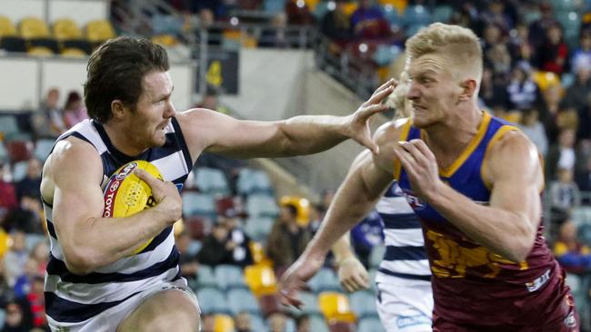 Patrick Dangerfield(left) of the Cats fends off a tackle by Nick Robertson of the Lions during the Round 16 AFL match between the Brisbane Lions and the Geelong Cats at the Gabba in Brisbane, Saturday, July 8, 2017. (AAP Image/Glenn Hunt) NO ARCHIVING, EDITORIAL USE ONLY