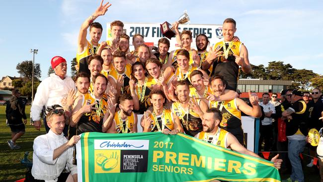 Frankston YCW show off their premiership flag after beating Bonbeach by 102 points in the Peninsula league grand final at Frankston Park. Picture: Mark Dadswell