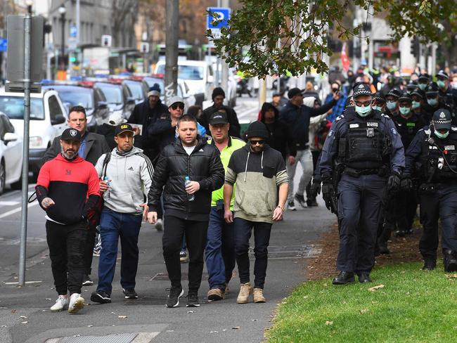 Police escort anti-vaccination and lockdown protesters in Melbourne yesterday. Picture: AFP