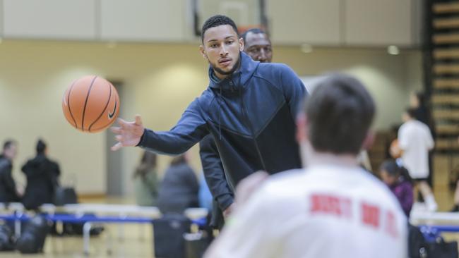 NBA star Ben Simmons passes with a young basketballer. Picture: Wayne Taylor.