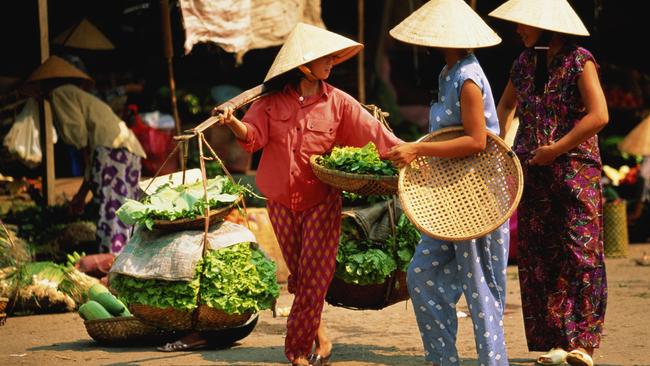 Traders carry produce through Dong Ba market in Hue. Picture: Getty Images