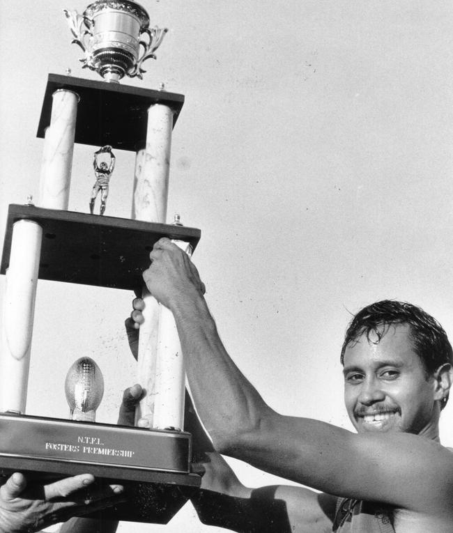 Darwin captain William “Ninny” Briston holds high the NTFL premiership cup in 1989.