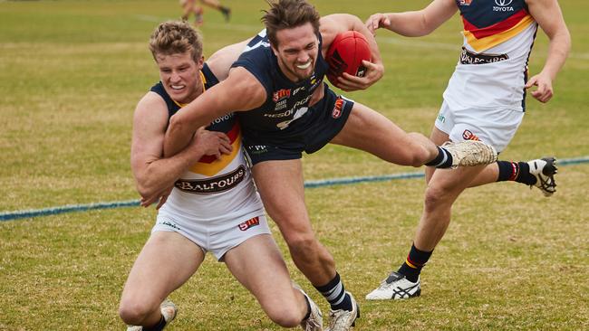 Harrison Wigg tackles South Adelaide's Ben Heaslip. Picture: MATT LOXTON