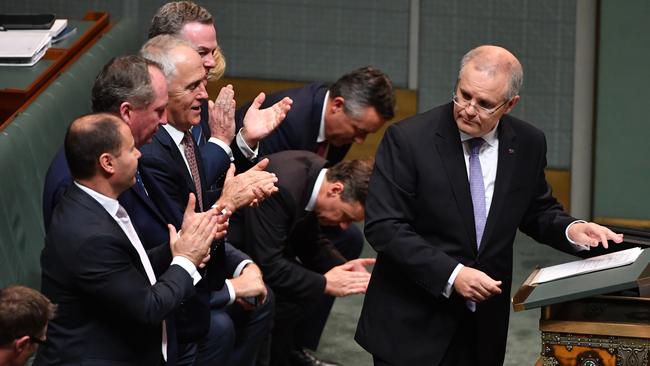 The government frontbench applaud Federal Treasurer Scott Morrison. Picture: AAP