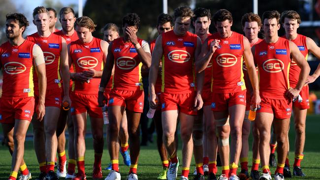 Dejected Suns players walk off the ground in Ballarat.