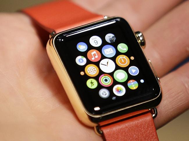 A woman holds the Apple Watch Edition during a demo following an Apple event Monday, March 9, 2015, in San Francisco. Make calls, read email, control music, manage Instagram photos, keep up with your workout, pay for groceries, open your hotel room door. CEO Tim Cook says you can do it all from your wrist with Apple Watch — for 18 hours a day. That's how long the battery will last on an average day. (AP Photo/Eric Risberg)