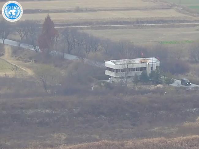 The North Korean defector passes a checkpoint along the south border in the Jeep.