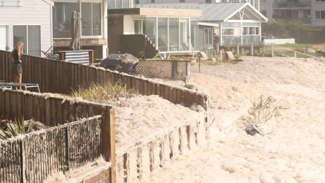 Homes inundated by seafoam on Monday. Picture: John Grainger