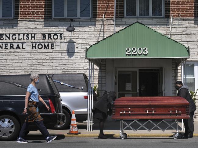 A pedestrian walks past a Brooklyn funeral home. New York's daily toll of coronavirus deaths has hit its lowest point in more than two weeks. Picture: AP