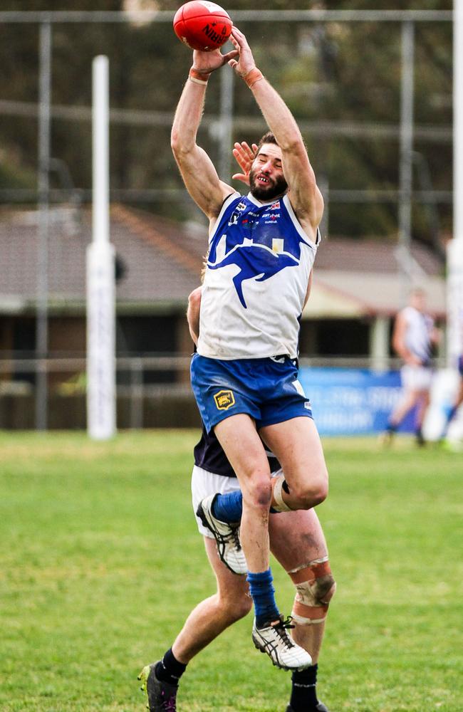 Sunbury Kangaroos Josh Burgess flies for an overhead mark. Picture: Aaron Cook.