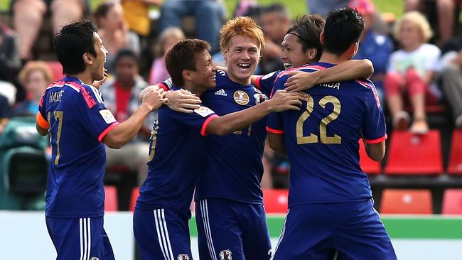 NEWCASTLE, AUSTRALIA - JANUARY 12: Japan players celebrate a goal during the 2015 Asian Cup match between Japan and Palestine at Hunter Stadium on January 12, 2015 in Newcastle, Australia. (Photo by Tony Feder/Getty Images)