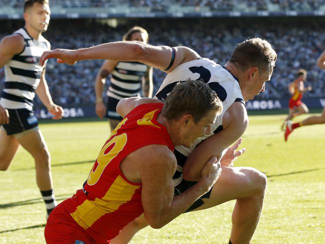 GEELONG, AUSTRALIA - MAY 22: Nick Holman of the Suns tackles Mitch Duncan of the Cats during the round 10 AFL match between the Geelong Cats and the Gold Coast Suns at GMHBA Stadium on May 22, 2021 in Geelong, Australia. (Photo by Darrian Traynor/AFL Photos/via Getty Images)