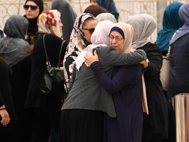 Women embrace before attending the funeral of a schoolboy killed in an accident at Banksia Road Primary School. Picture: AAP Image/David Moir.