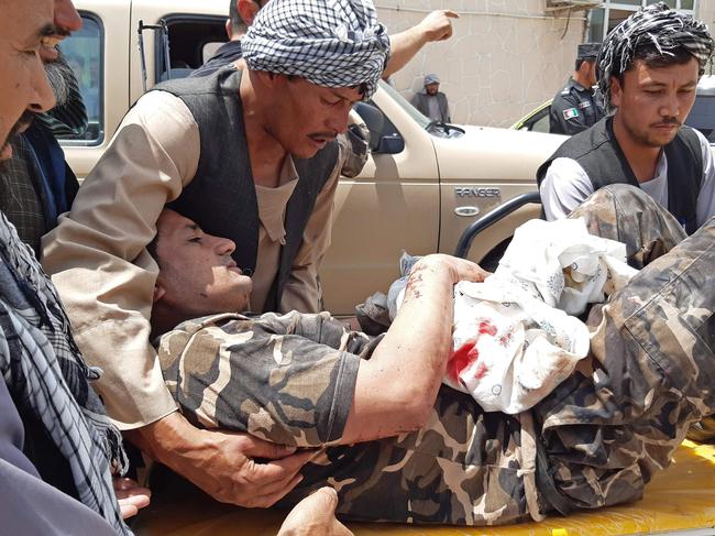 A wounded personnel of National Directorate of Security (NDS) is brought on a stretcher to a hospital after a car bomb exploded in the city of Aybak, in Samangan province on July 13, 2020. - A car bomb claimed by the Taliban exploded on July 13 near the offices of Afghanistan's intelligence agency in the north of the country, wounding dozens of people, officials said. The insurgents described it as a "complex attack" involving a suicide bomber in a car, with reports of ongoing gunfire. (Photo by - / AFP)