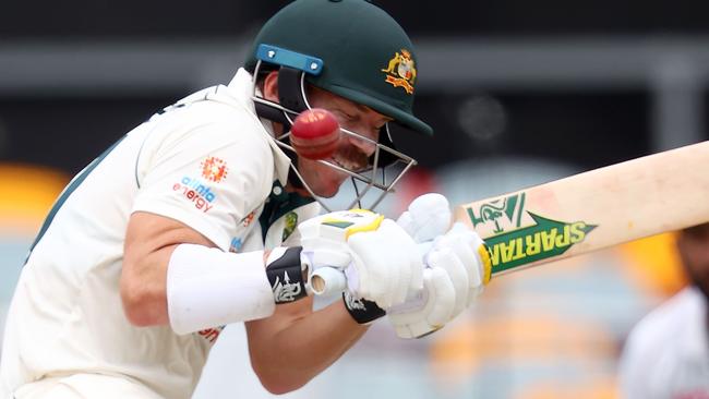 Australia's batsman David Warner tries to avoid a bouncer from India's Shardul Thakur on day four of the fourth cricket Test match between Australia and India.