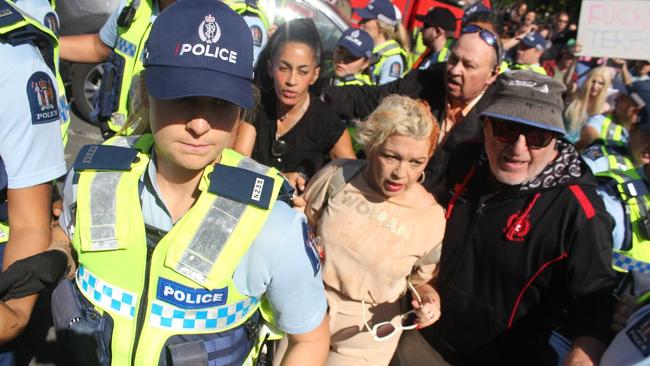 Kellie-Jay Keen-Minshull is escorted from the rally by police. Picture: Dylan Reeve