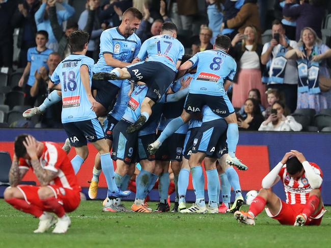 The agony and ecstasy of a Grand Final in one photograph. Picture: Brett Costello