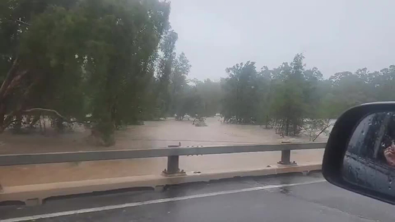 Powerlines and floodwater at Ollera Ck bridge, Bruce Hwy