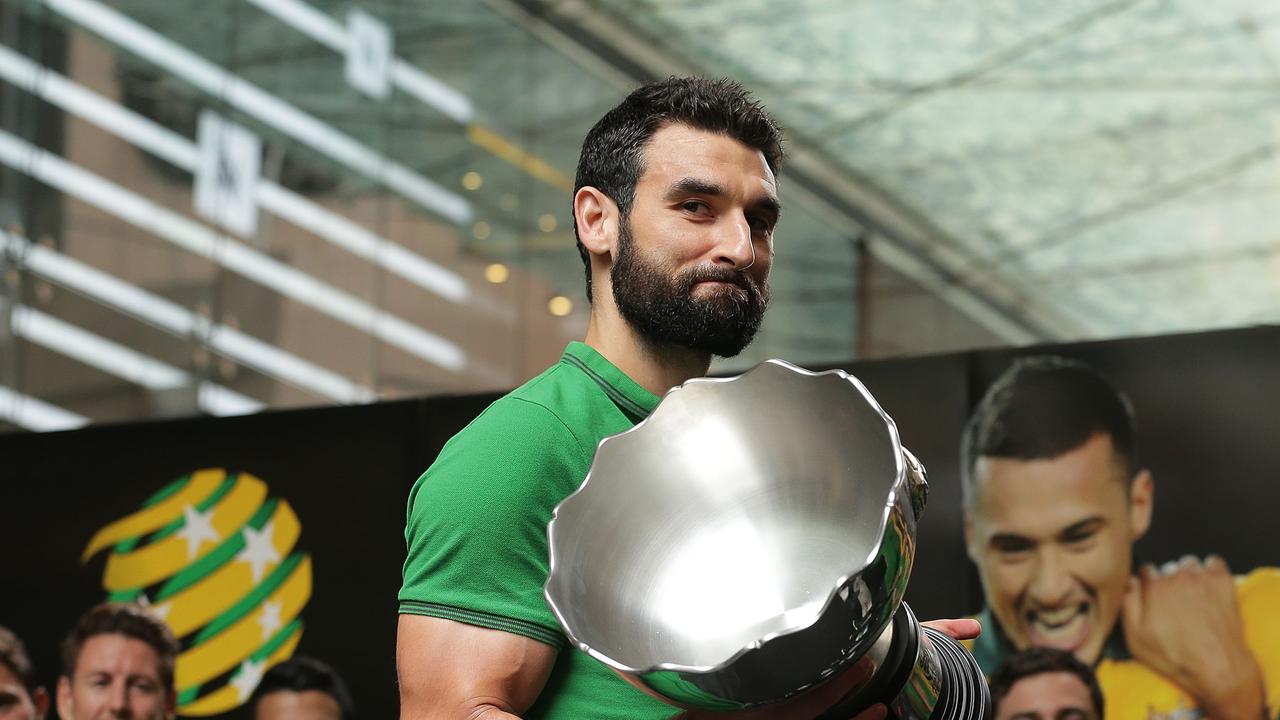 SYDNEY, AUSTRALIA - FEBRUARY 01: Socceroos captain Mile Jedinak holds aloft the Asian Cup during celebrations at Westfield Sydney on February 1, 2015, after the Socceroos won the 2015 Asian Cup last night, in Sydney, Australia. (Photo by Mark Metcalfe/Getty Images)