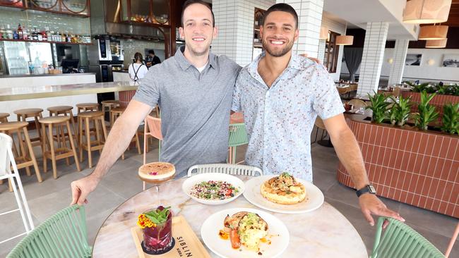 Owners TJ Cianci (L) and Jarrod Kyle inside the venue with some dishes from the menu. Picture: Richard Gosling