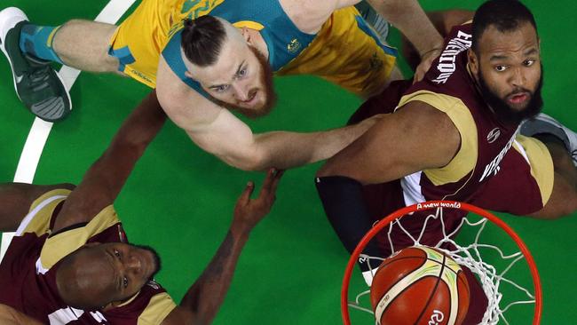 Venezuela's power forward Miguel Ruiz, Australia's forward Aron Baynes and Venezuela's centre Gregory Echenique eye a rebound during their Olympic clash.