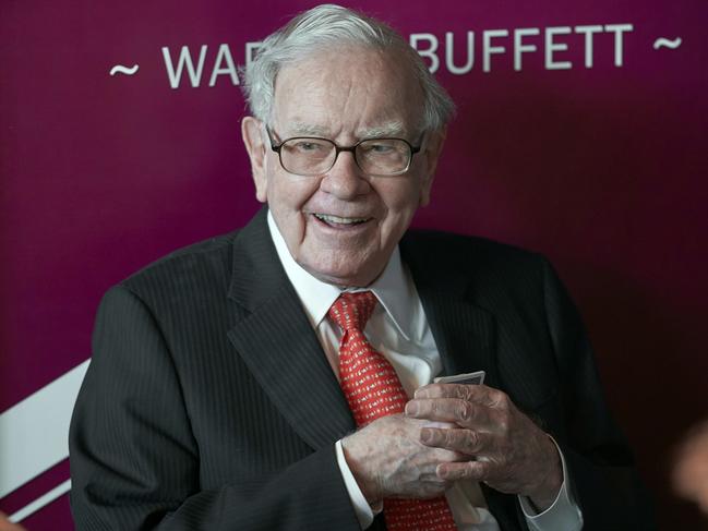FILE - Warren Buffett, chairman and CEO of Berkshire Hathaway, smiles as he plays bridge following the annual Berkshire Hathaway shareholders meeting in Omaha, Neb., May 5, 2019. (AP Photo/Nati Harnik, File)