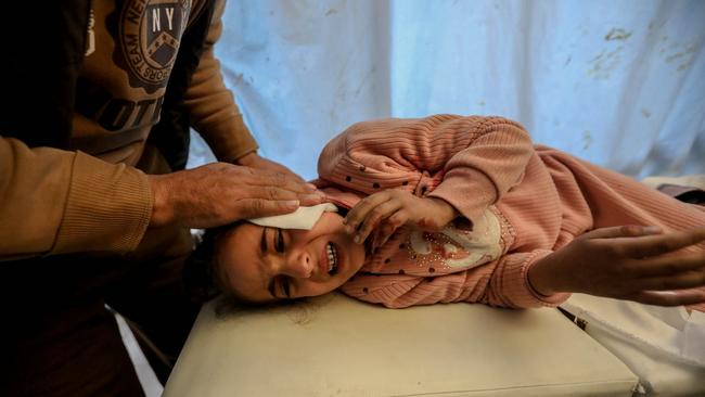 A Palestinian child injured in an Israeli air strike receives treatment at Nasser Medical Hospital. Picture: Ahmad Hasaballah/Getty Images