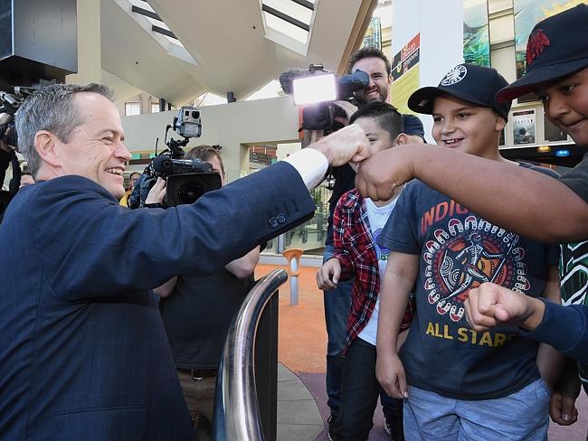 Shorten awkwardly fist bumps with these kids. Picture: AAP Image/Mick Tsikas