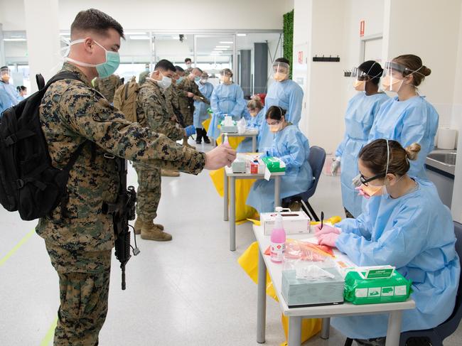 A combined medical team from ADF Joint Health Unit - Central Australia, NT Health, National critical care - trauma response centre and the US Marine Corps, conduct pre-quarantine health screening for recently arrived US Marines of Marine Rotational Force - Darwin, at RAAF Base Darwin, NT. *** Local Caption *** The first 200 US Marines from the 2020 Marine Rotational Force â Darwin arrived at RAAF Darwin today. Each Marine was screened four days prior to departure to Australia. They were then screened and tested for COVID-19 upon arrival in Australia, before being quarantined for 14 days at specially prepared Defence facilities in the Darwin area. Each Marine will be re-tested at the conclusion of the quarantine period. The modified rotation will involve around 1,200 Marines who will exercise exclusively at Defence training areas in the Northern Territory until September. As announced on 6 May, a modified deployment of Marine Rotational Force â Darwin would proceed this year, following careful planning and preparations undertaken by both Australia and the United States to minimise COVID-19 risks to the Northern Territory.