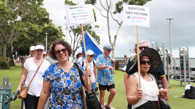 A large crowd up to 1500 people attended the Worldwide Rally for Freedom north of Muddy's Playground, before marching down the Esplanade and through the Cairns CBD. Rosemary Bishop and Carmelita Almain carry placards at the march along the Esplanade. Picture: Brendan Radke